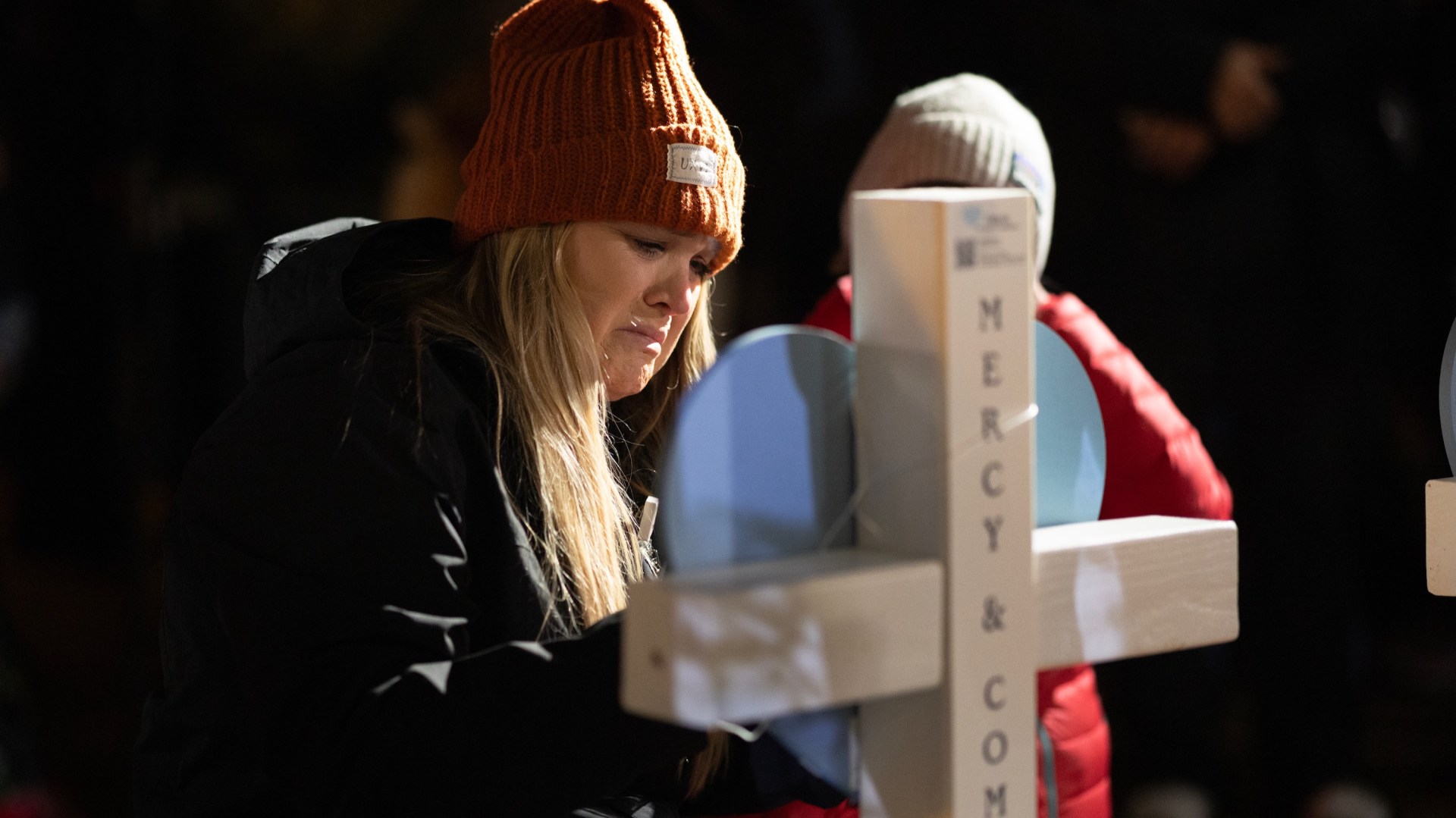 Locals gather to mourn at a vigil for victims of the Abundant Life Christian School shooting.