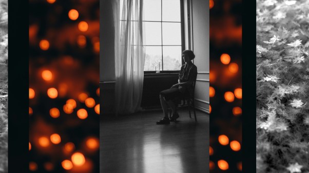 Woman sitting alone in a room with lights and snowflakes