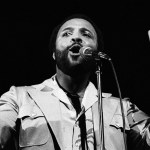 An image of Andraé Crouch performing.