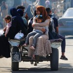 Displaced Palestinians travel on a cart in Rafah, southern Gaza Strip