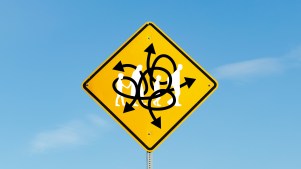 A street sign with arrows mixed up and an immigrant family walking through it