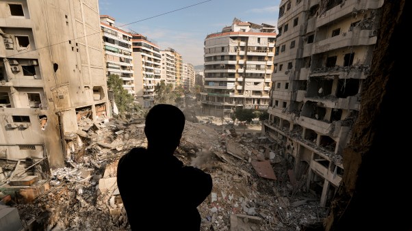 A man pauses as he looks at the rubble of destroyed buildings in Dahiyeh, Beirut, Lebanon