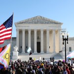 Supreme Court with an American flag and Transgender flag in front of it