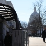 two people walking in DC in front of the Capitol building