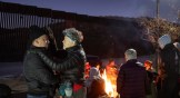 A minister in Arizona prays for a Colombian migrant waiting to be picked up by border patrol the night before Donald Trump's inauguration.