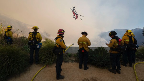 An LA County helicopter does a water drop on the Palisade Fire in Los Angeles.
