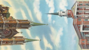 A Catholic church with it's steeple pointing to the steeple of a Protestant church