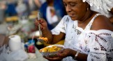 A woman prepares a dish of acaraje at the Ipanema fair, in Rio de Janeiro, Brazil.