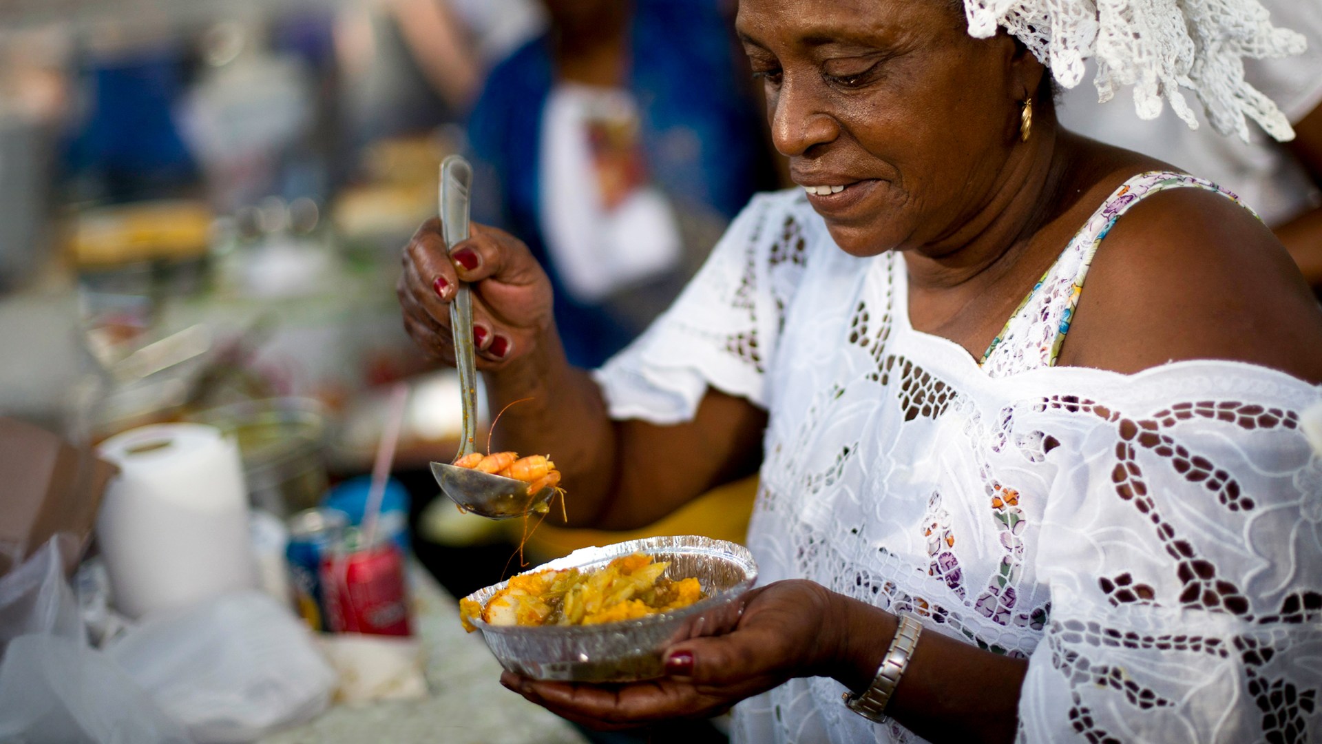 A woman prepares a dish of acaraje at the Ipanema fair, in Rio de Janeiro, Brazil.
