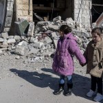 Children inspect the destroyed buildings after an Israeli attack in Lebanon.