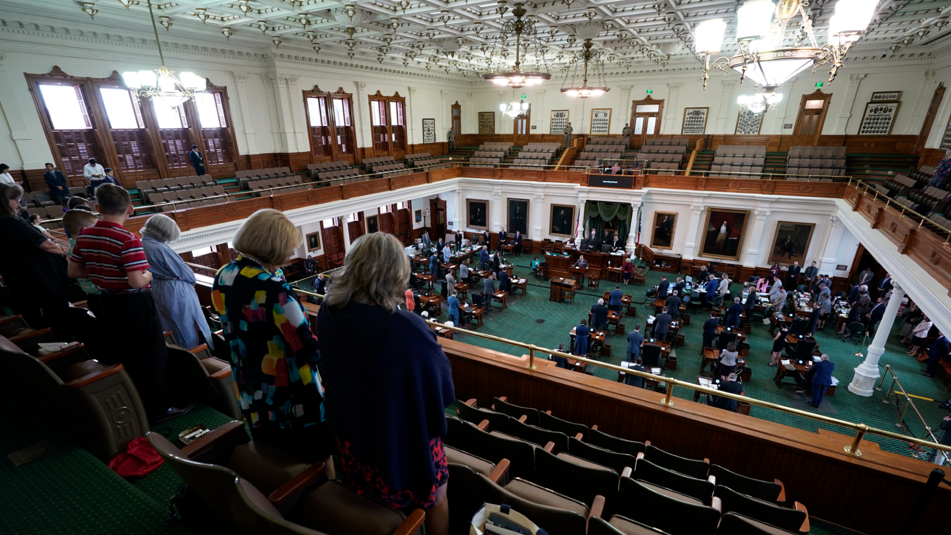 Women watch the Texas legislature in session.
