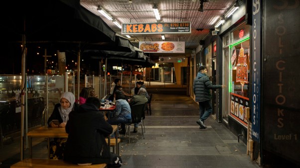Mridula Amin Restaurant goers sit in a Main Street in Dandenong, a southeastern suburb of Melbourne, at night.