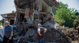 A Ukrainian man surveys the ruins of a Baptist church destroyed in the Russian invasion.