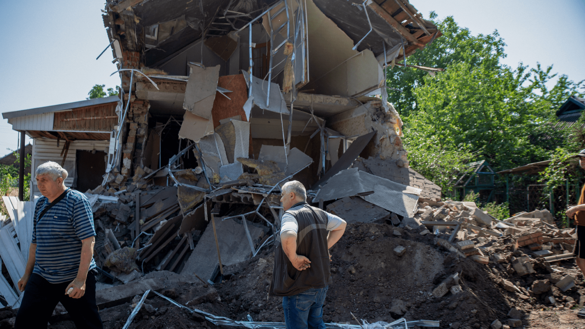 A Ukrainian man surveys the ruins of a Baptist church destroyed in the Russian invasion.