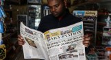 A man in Kenya reads the newspaper about the impact of President Donald Trump's cuts to USAID.