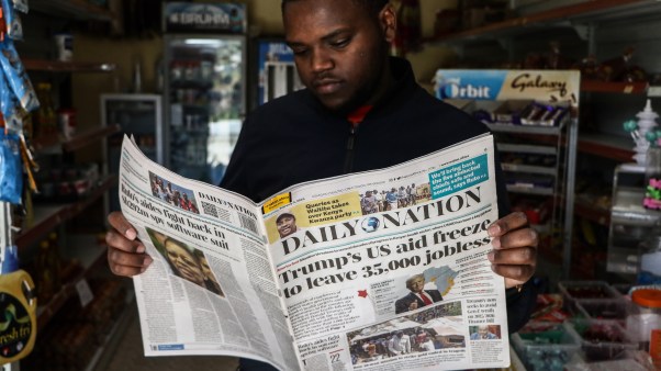 A man in Kenya reads the newspaper about the impact of President Donald Trump's cuts to USAID.