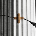 A column with a bandaid over a crack that has the shape of a cross