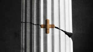 A column with a bandaid over a crack that has the shape of a cross