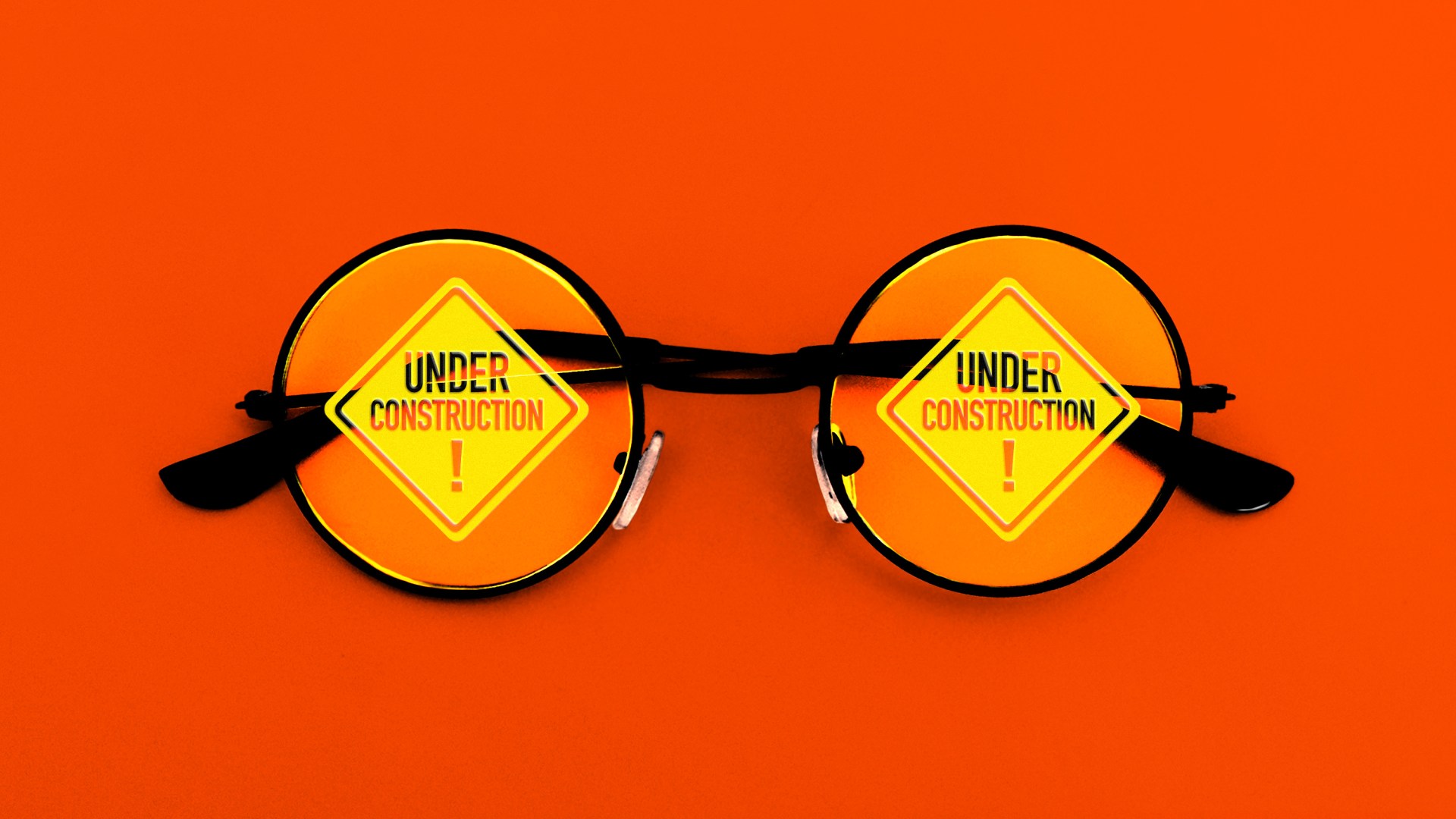 A pair of glasses with construction signs on the lenses.