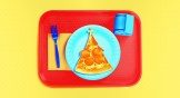 A school lunch tray with pizza that looks like a church steeple