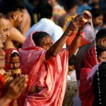 Pilgrims pray before taking a holy dip in Sangam during the Maha Kumbh Mela festival.