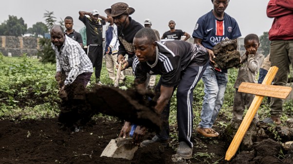 Relatives and friends cover a grave during a funeral for a victim of violence from M23 in Goma, Democratic Republic of Congo.