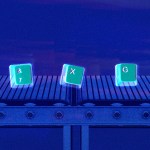 Keyboard letter keys on a conveyor belt.