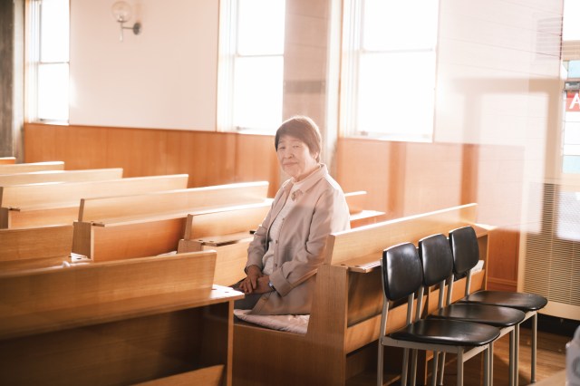 Mizuno Akiko, pastor at Ina Gospel Church, sits in a church pew in Ina City, Nagano Prefecture