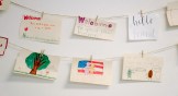 A string of welcome signs hand-drawn by kids