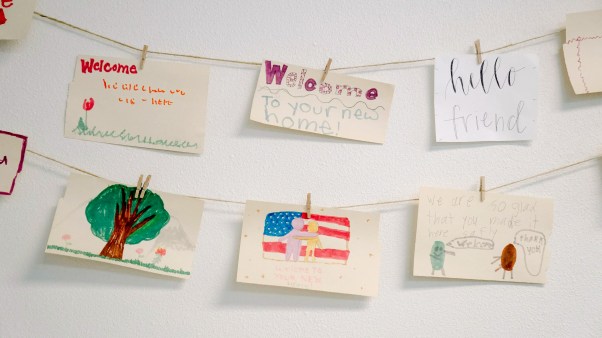 A string of welcome signs hand-drawn by kids