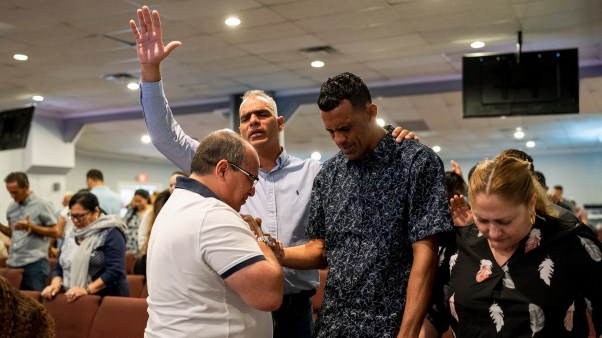 Parishioners pray for undocumented immigrants during a 2023 service at Iglesia Rescate in Miami.