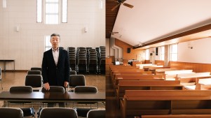 Man stands in empty church surrounded by empty chairs and empty pews in Japan.