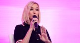 Paula White speaking in front of a pink screen