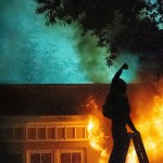 A photo of someone setting fire to a house.