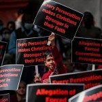 Christian activists display placards in a peaceful protest rally in New Delhi.