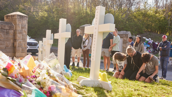 People pray at a makeshift memorial after a school shooting in Nashville.