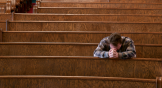 Middle age white man with head down in the pews