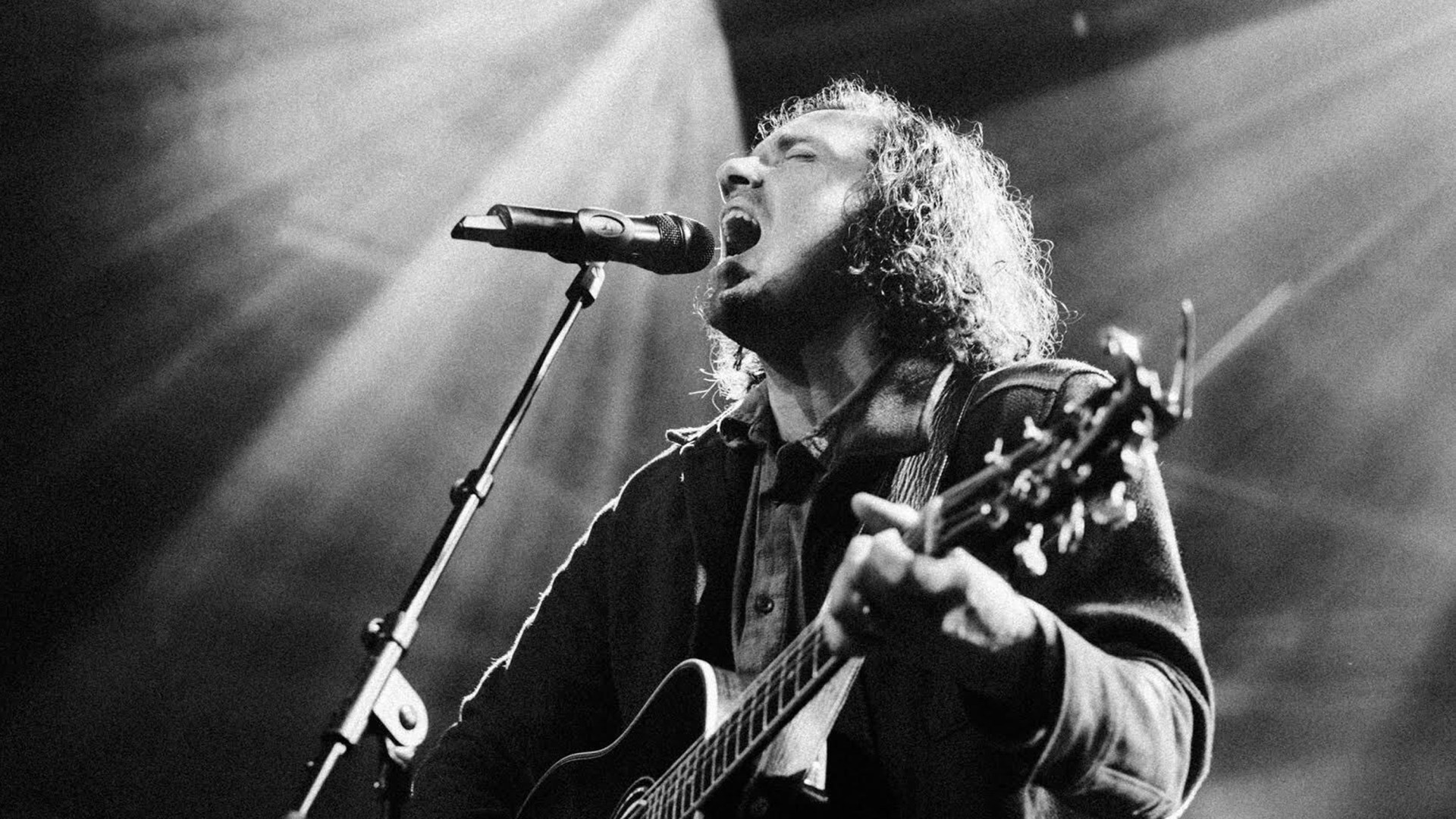 Josh Garrels singing and playing the guitar