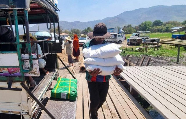 Workers from Partners Relief and Development unloading supplies.