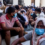 Scam center victims sit on the ground during a crackdown operation by the Karen Border Guard Force (BGF) in Myanmar.