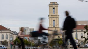 Blurry people walk past a church in Potsdam, Germany