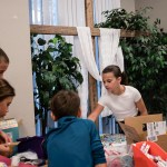 Students with school supplies in front of a cross