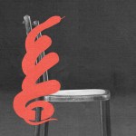 A red snake coiled around an empty chair