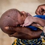 A mother holding her young baby at one of the nutrition clinics in Nigeria.