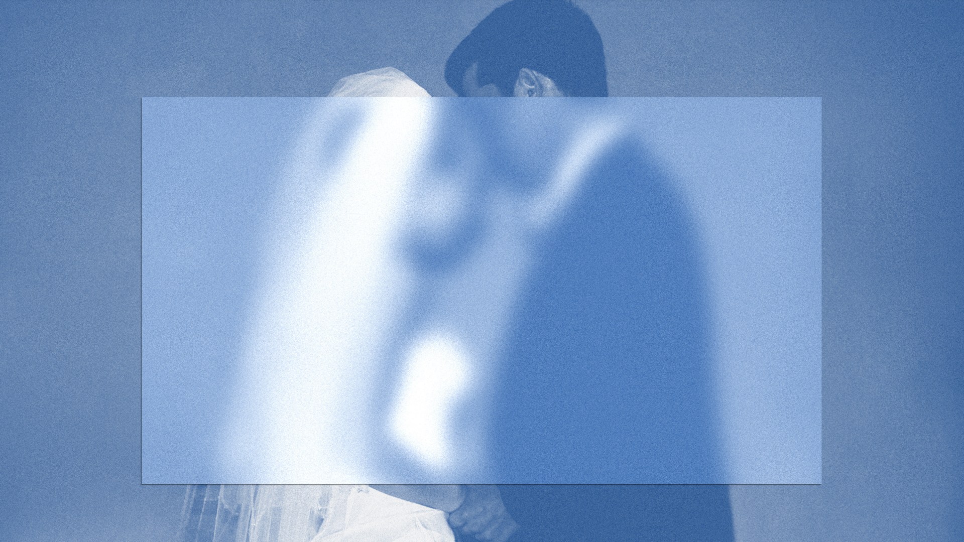 A partially blurred image of a bride and groom exchanging vows.