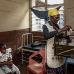 A mother and child await treatment in April at a Kenyan clinic that treats HIV/AIDS. Many such clinics are shuttering after USAID cuts.