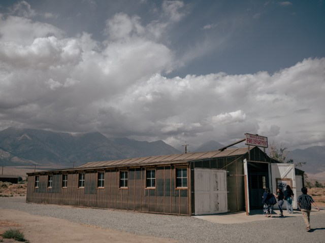 A group of Asian Americans enters the Manzamar internment camp in California.