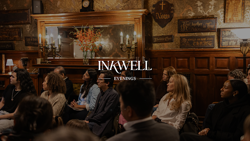 People sitting and listening to a presentation at an Inkwell event