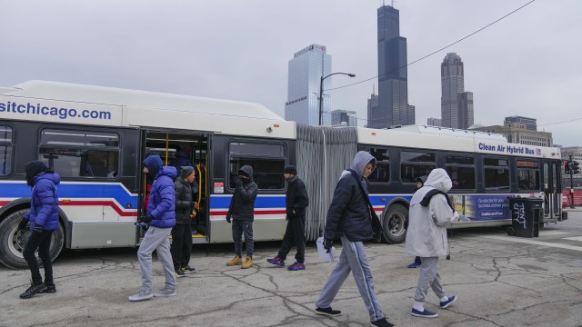 Migrants used city warming buses in downtown Chicago to escape the cold in January, 2024.