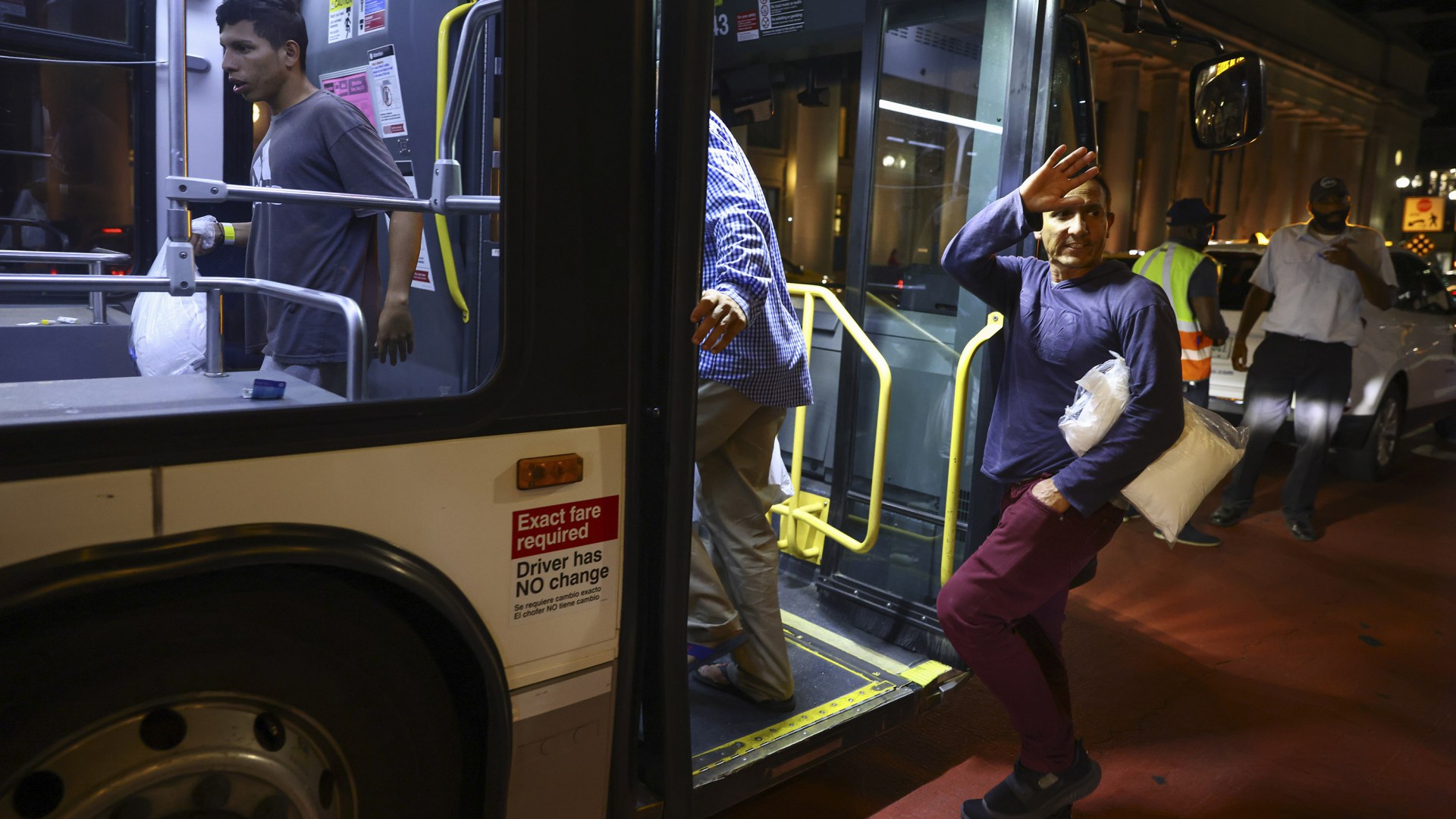 Migrants in Chicago board a bus to a downtown welcome center in August, 2022.